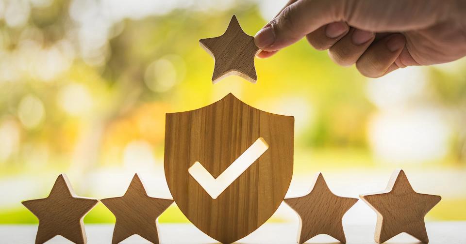 House symbol with a protective shield representing homeowners insurance