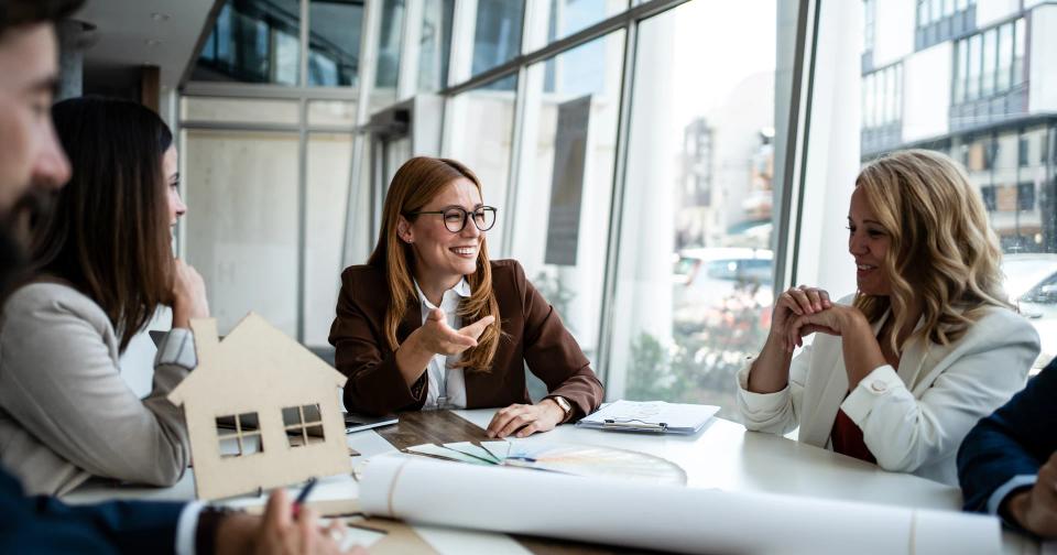 Real estate professionals discussing a home purchase strategy