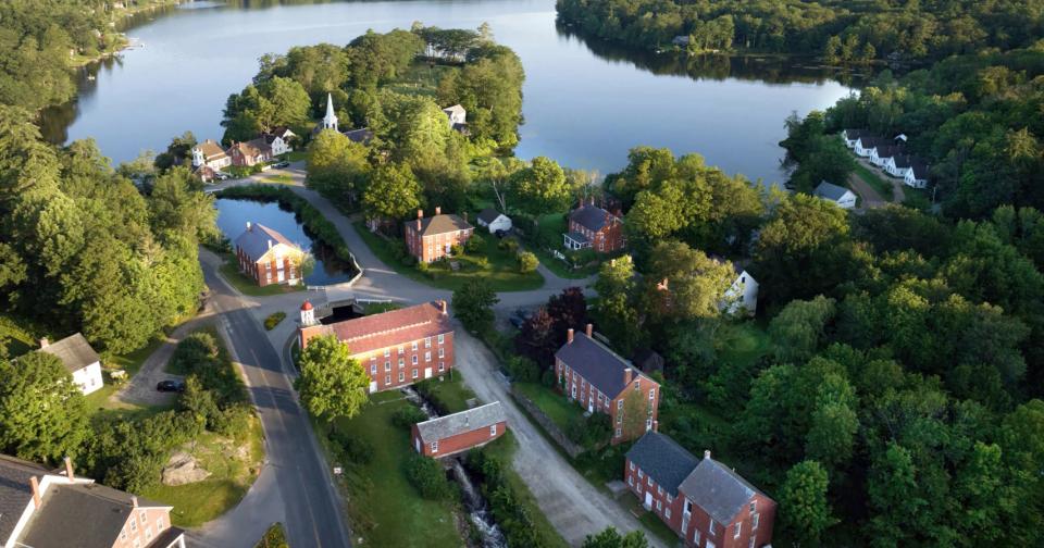 Aerial view of a New Hampshire town surrounded by trees and lakes