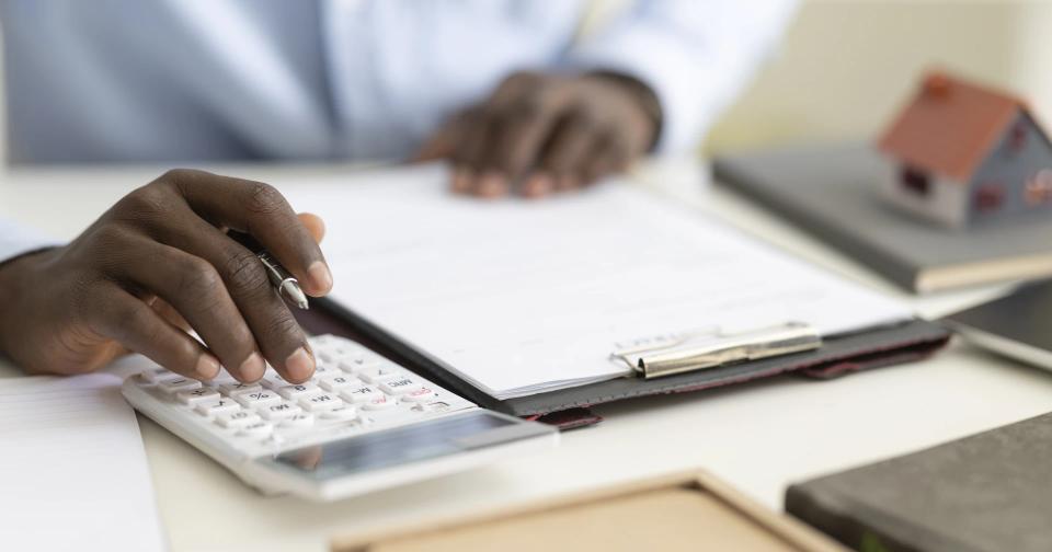 Homebuyer reviewing real estate documents and financing information